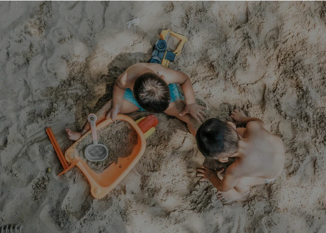 Children playing in the sand.