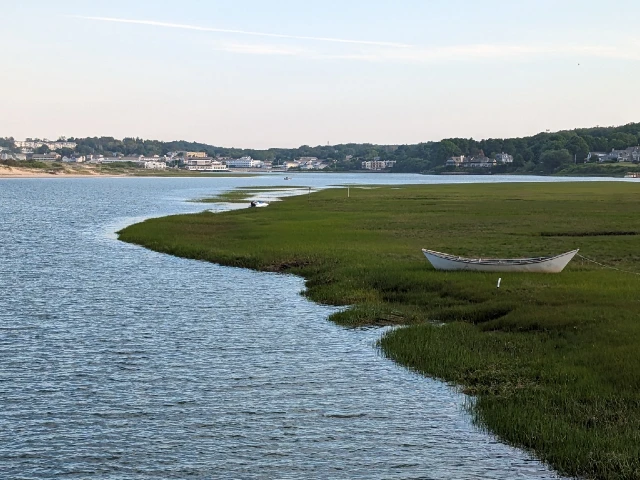 A view from the Footbridge Beach footbridge of a rowboat sitting in the marsh on the Ogunquit river.
